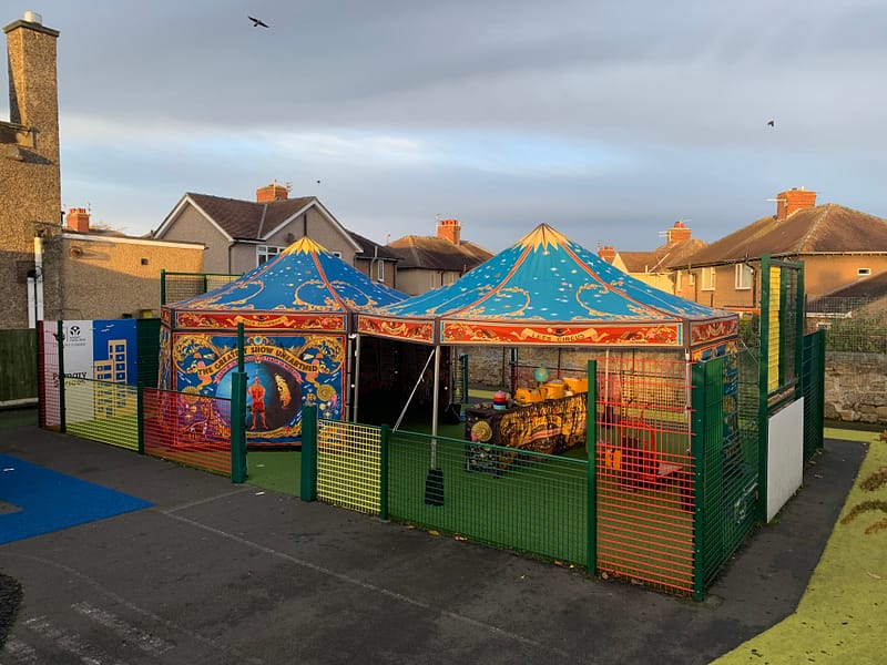 Two incredibly illustrated hexagonal gazebos create the Rocks Showman's Booth - a mobile museum, theatre, gallery and classroom