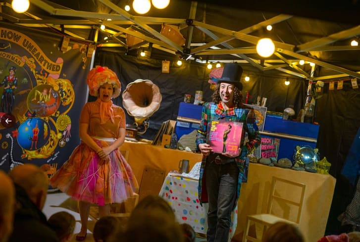 The Rock Showman holds a 'rock record' with the gramophone in the background. A comedy scene from The Greatest Show Unearthed