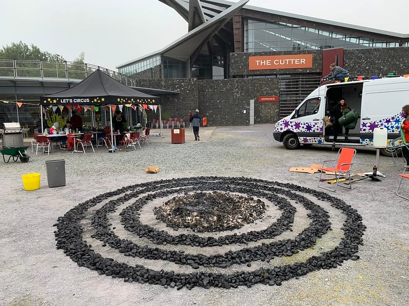 Three rings and a circle of coal laid out on the floor of Woodhorn Colliery make a sculpture during an artist residency