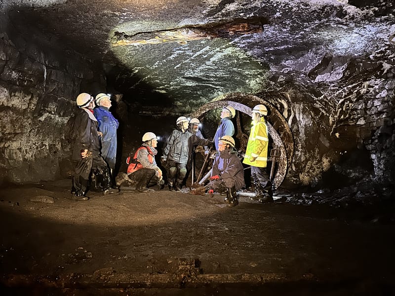 a group of underground explorers in an abandoned lead mine